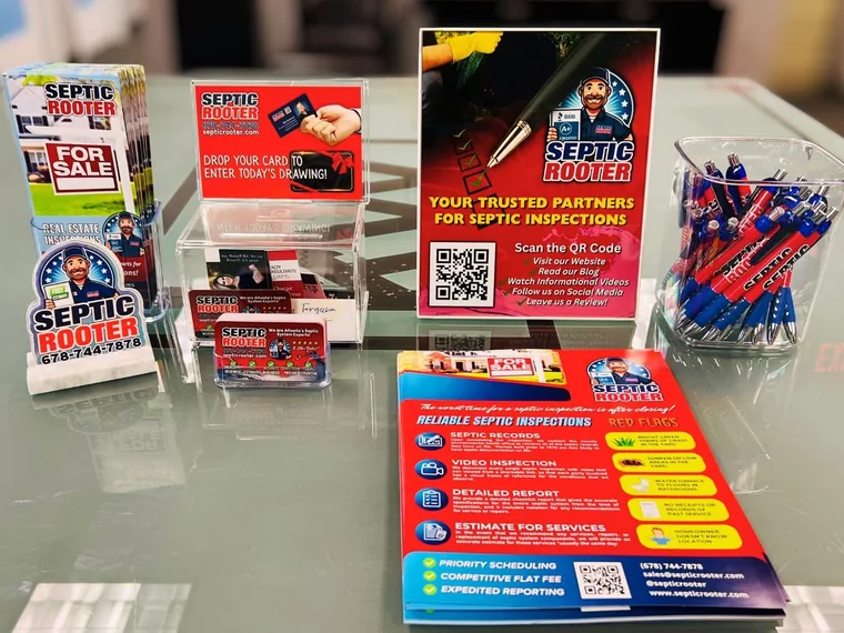 SepticRooter real estate inspection marketing materials and handouts on a brokerage table