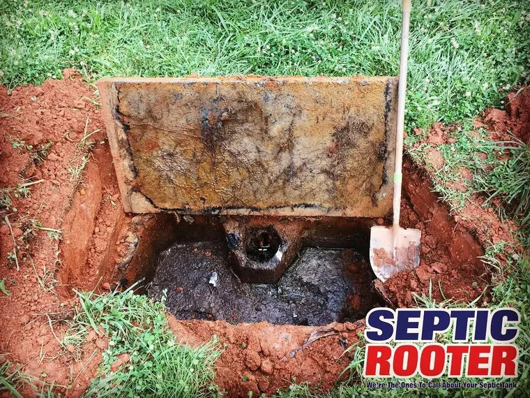 Opened septic tank showing the inlet baffle during a diagnosis